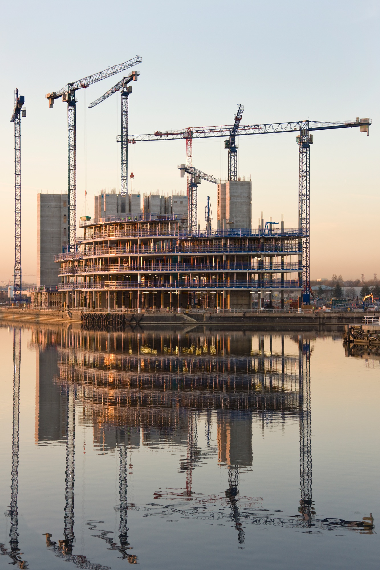 Construction cranes building a waterside office development